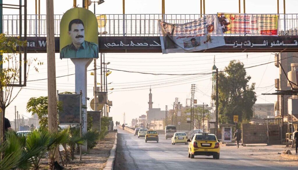 An image of Abdullah Ocalan overlooks a road in Syria